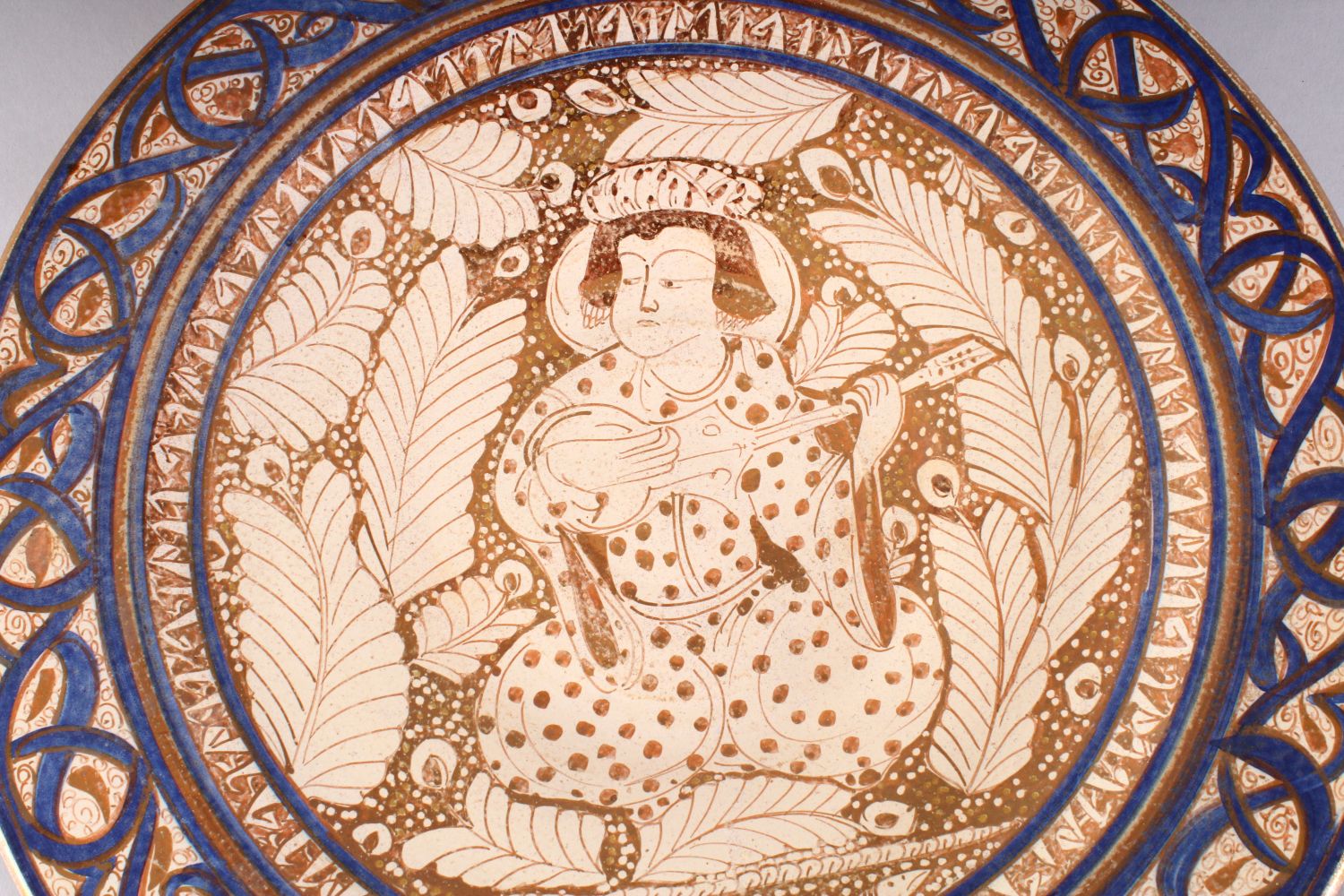 A GOOD 19TH CENTURY ISLAMIC PERSIAN POTTERY PLATE, the central decorated with an immortal / - Image 2 of 7