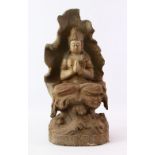 A LATE 19TH CENTURY CHINESE CARVED WOODEN FIGURE OF SEATED GUANYIN, with poly chromed decoration,