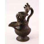 A FINE 17 / 18 CENTURY NEPALESE BRONZE OIL LAMP EWER, with a moulded hand on the handle, the spout