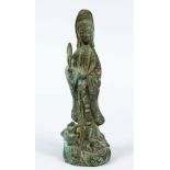 A GOOD EARLY CHINESE BRONZE FIGURE OF GUANYIN, stood with an emerging lion dog holding two