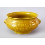 A GOOD CHINESE YELLOW GLAZED PORCELAIN TRIPOD CENSER, The censer carved with scenes of chilong in