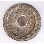 A 19TH CENTURY INDAIN SILVERED CHARGER / DISH, with embossed decoration, 25cm,