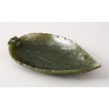 AN EARLY 20TH CENTURY CHINESE CARVED JADE BRUSH WASHER IN THE FORM OF A LEAF, with a lion dog head