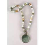 A GOOD CHINESE CARVED JADE / HARD STONE BEAD NECKLACE AND PENDANT, Approx 76cm.