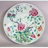 A GOOD AND LARGE 19TH CENTURY CHINESE CELADON FAMILLE ROSE PORCELAIN DISH, decorated with a native