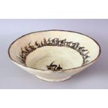 AN IRANIAN NISHABOUR POTTERY BOWL WITH CALLIGRAPHY AND LARGE BIRD, the inner decorated with