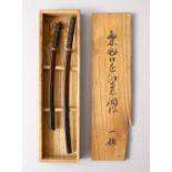 A GOOD BOXED PAIR OF JAPANESE MEIJI PERIOD MINIATURE SWORDS, in original signed tomobako, 21cm &