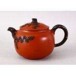 A CHINESE YIXING CLAY TEAPOT - PINE TREES, The base with an impressed seal mark, 9.5cm high x 15cm