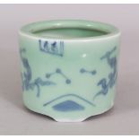 AN ORIENTAL UNDERGLAZE-BLUE & CELADON PORCELAIN TRIPOD CENSER, painted with small panels of