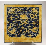 AN UNUSUAL LARGE CHINESE MING STYLE YELLOW & BLUE PORCELAIN TILE, with incised decoration of dragons