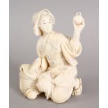 A GOOD JAPANESE MEIJI PERIOD CARVED IVORY OKIMONO OF A LADY HOLDING A PEACH, the lady in a seated