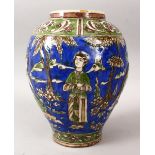 AN EARLY QAJAR POTTERY JAR, decorated with figures upon a blue ground within landscapes, 30cm high x
