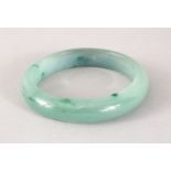 A GOOD 19TH / 20TH CENTURY CHINESE CARVED JADEITE BANGLE, 7cm & internal 5cm.