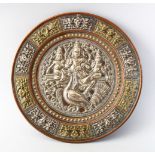AN INDIAN TANJORE SILVER OVERLAID DISH, the central panel depicting three figures and a bird, the