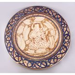 A GOOD 19TH CENTURY ISLAMIC PERSIAN POTTERY PLATE, the central decorated with an immortal /