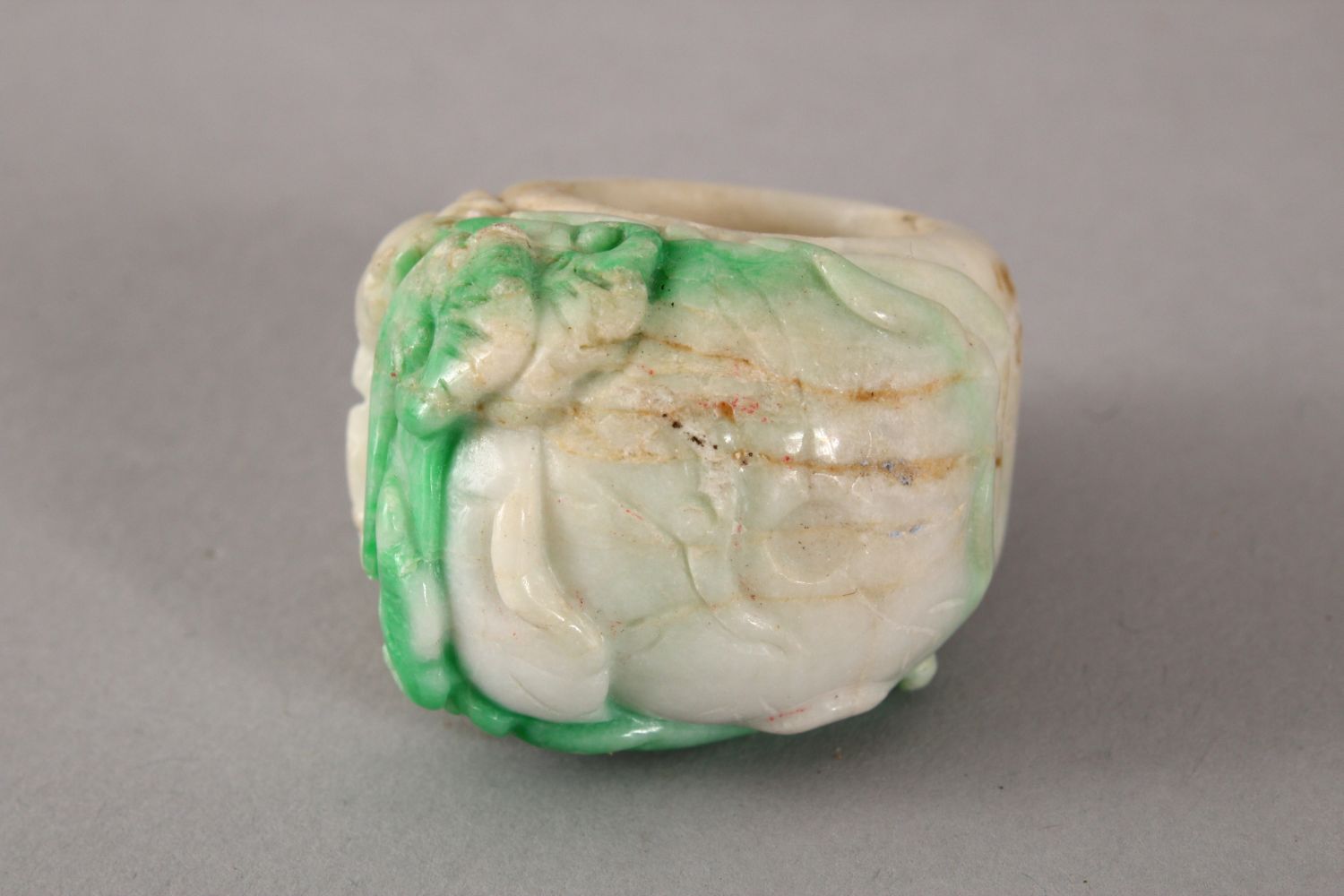 A 20TH CENTURY CHINESE CARVED JADEITE RING, the ring carved with fish amongst lotus, 4cm, internal - Image 2 of 2