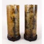 A PAIR OF 19TH / 20TH CENTURY CHINESE CARVED JADE CYLINDRICAL VASES, mounted to hardwood stands,