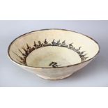 AN IRANIAN NISHABOUR POTTERY BOWL WITH A BIRD, the inner decorated with a bird, 24.5cm.