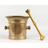 A LARGE POLISHED BRONZE PESTLE AND MORTAR. 8ins high.