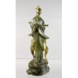 A CARVED SOAPSTONE FIGURE OF GUANYIN.