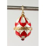 A SMALL RUSSIAN SILVER, RED AND WHITE ENAMEL EGG SHAPED PENDANT. 0.75ins long.