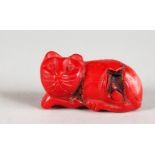 A SMALL CARVED CORAL MODEL OF A CAT. 1.25ins long.