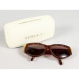 A PAIR OF VERSACE SUNGLASSES, MOD 389 COL 869 OD, in a white Versace case.