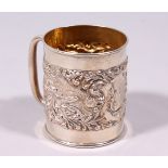 A SMALL CHRISTENING MUG, repousse with a hound attacking a boar. Birmingham 1908.