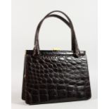 A BLACK CROCODILE SKIN HANDBAG, 10ins.