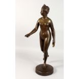 A CLASSICAL STYLE BRONZE STANDING FEMALE NUDE. Signed Houdon. 24ins high.