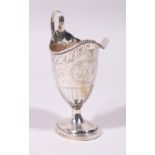 A GOOD GEORGE III ENGRAVED HELMET SHAPED MILK JUG, with reeded handle and base. London 1782.