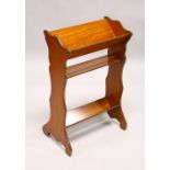 A LATE 19TH CENTURY SATINWOOD BOOK TROUGH, the two book troughs united by a shelf, with shaped sides