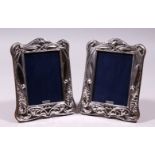 A PAIR OF SILVER AND ENAMEL ART NOUVEAU DESIGN UPRIGHT PHOTOGRAPH FRAMES. 7.5ins x 5.5ins.