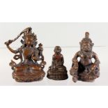 THREE SMALL BRONZE FIGURES OF SEATED BUDDHAS. 3ins high and smaller.