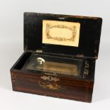 A VICTORIAN ROSEWOOD CASED MUSIC BOX, playing on four airs. 19ins long.