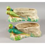 CLARICE CLIFF, A PAIR OF BUDGERIGAR POTTERY PLANTERS, moulded as a pair of birds next to a tree