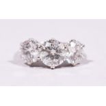 A VERY GOOD 18CT WHITE GOLD THREE STONE DIAMOND RING of 3.84cts.