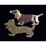 TWO SILVER DACHSHUND DOG BROOCHES.