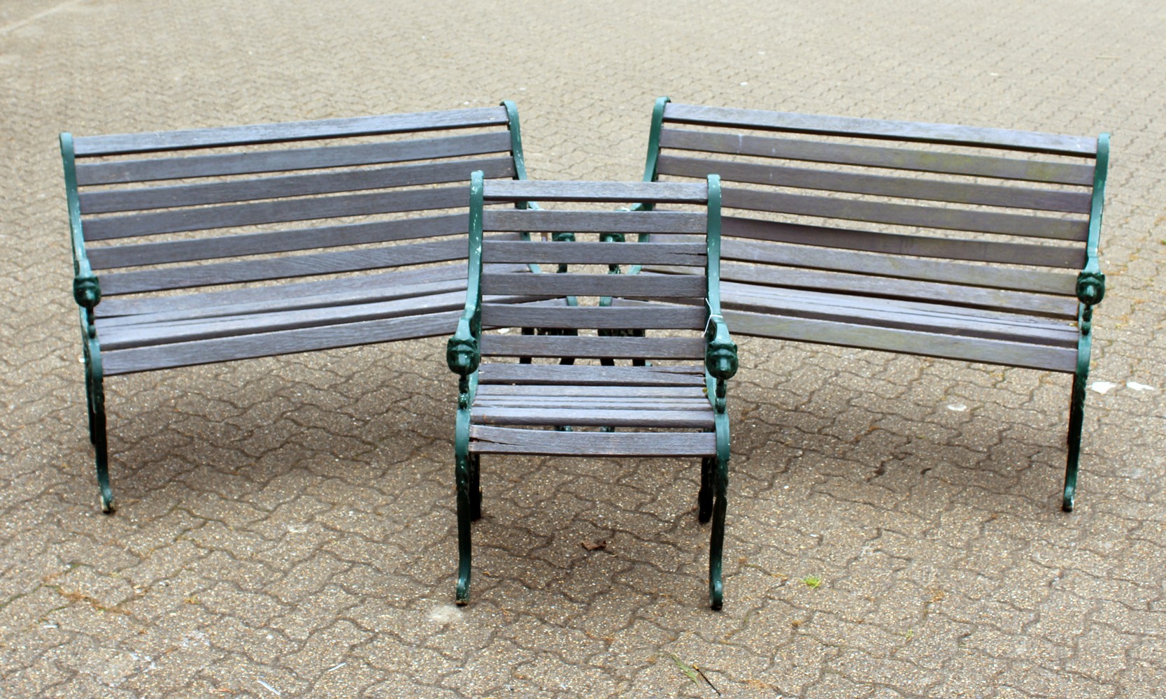 A PAIR OF VICTORIAN STYLE GARDEN BENCHES, each with ornate cast metal ends and wooden slats;