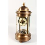 A LARGE CIRCULAR BRONZE CASED TABLE CLOCK, with enamel dial, eight-day movement, striking on a gong.