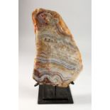 A LARGE AGATE SPECIMEN, mounted on a stand. Agate: 11ins high.