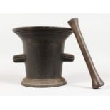 A LARGE CAST IRON PESTLE AND MORTAR. 8.5ins high.