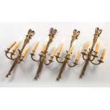 A SET OF FOUR CLASSICAL STYLE ORMOLU RIBBON AND BOW THREE LIGHT WALL APPLIQUES. 2ft 0ins high.