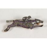 A 9CT GOLD AND SILVER DIAMOND SET HORSE AND JOCKEY BROOCH.