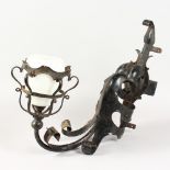 A GOTHIC STYLE WROUGHT IRON WALL LIGHT, with opaque glass shade. 18ins high.