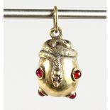 A SMALL RUSSIAN SILVER GILT AND GARNET SET SNAKE EGG PENDANT. 1ins long.