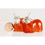 A PAIR OF NOVELTY AMBER AND .800 RABBITS.