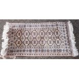 A 20TH CENTURY PERSIAN STYLE RUG, beige ground with geometric motifs. 5ft 5ins x 3ft 2ins.
