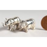 TWO CAST SILVER NOVELTY RHINO AND HIPPO FIGURES.