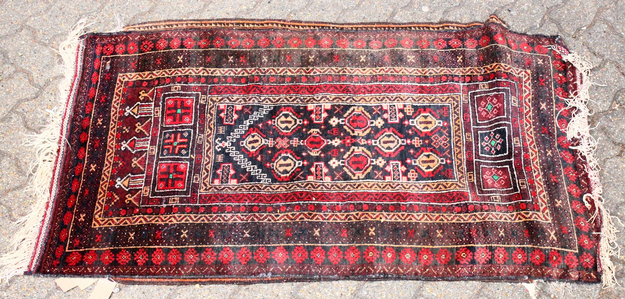 A SMALL 20TH CENTURY PERSIAN PRAYER RUG, black ground with stylised motifs. 5ft 0ins x 2ft 9ins.